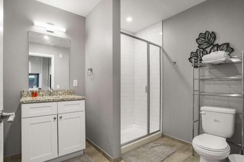 a bathroom with a shower and a toilet and a sink at CozySuites Stunning 1BR in Downtown Pitts 40 in Pittsburgh