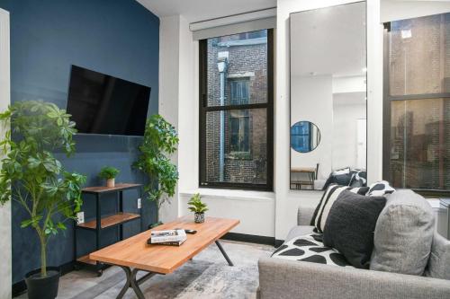 a living room with a couch and a table at CozySuites Stunning 1BR in Downtown Pitts 44 in Pittsburgh