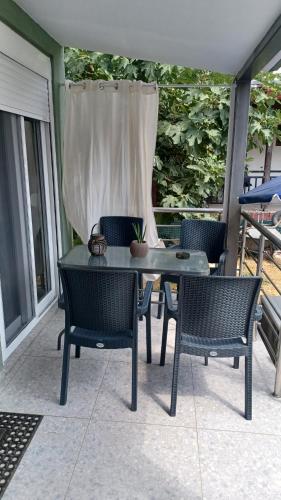 a table and chairs sitting on a patio at Modern House Close to the Sea Asprovalta in Asprovalta