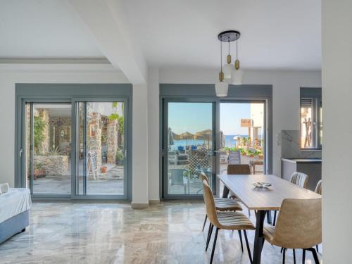a kitchen and dining room with a table and chairs at Diōni by the Beach in Kardamaina