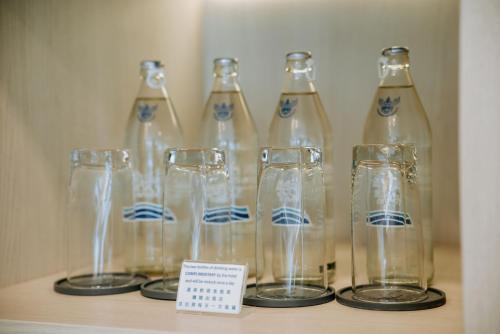 a row of empty glass bottles on a shelf at BlueSotel Krabi AoNang Beach in Ao Nang Beach