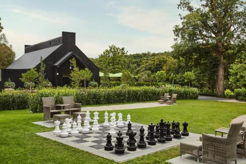 a chessboard in a garden with a black building at Cabra Castle Hotel in Kingscourt