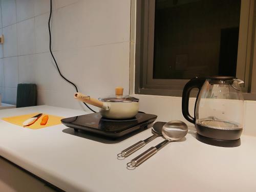 a kitchen counter with a tea kettle and spoons at New 2BR or 3BR Da Men Residence 7 Min to Sunway Near BRT in Subang Jaya