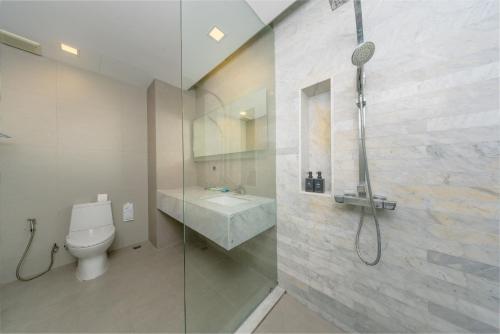 a bathroom with a shower and a toilet and a sink at BlueSotel Krabi AoNang Beach in Ao Nang Beach