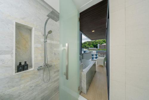 a bathroom with a shower and a sink at BlueSotel Krabi AoNang Beach in Ao Nang Beach