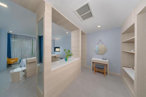 a bathroom with a sink and a desk in a room at BlueSotel Krabi AoNang Beach in Ao Nang Beach