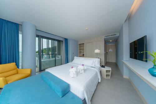 a bedroom with two teddy bears sitting on a bed at BlueSotel Krabi AoNang Beach in Ao Nang Beach