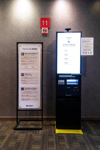 a large screen on a wall next to a sign at Hotel Modak Namdaemun in Seoul