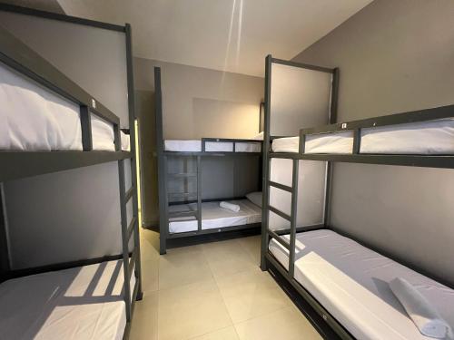 a room with three bunk beds in a room at Candea Cocoon Kandy in Kandy