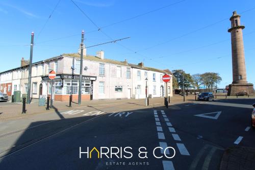 an empty street in front of a large building at Light House View in Fleetwood