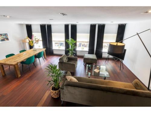 a living room with a couch and a table at Central Domburg Apartment in Domburg