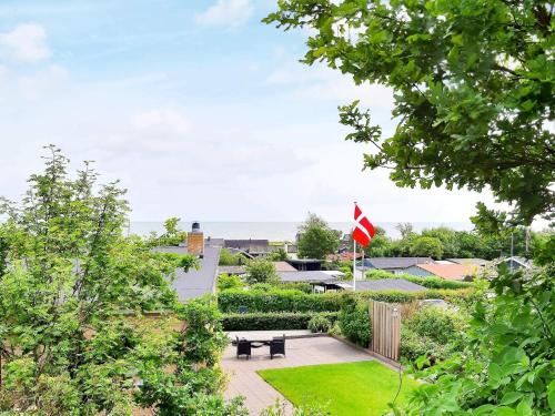 a garden with a picnic table and a flag at 8 person holiday home in Sæby-By Traum in Sæby