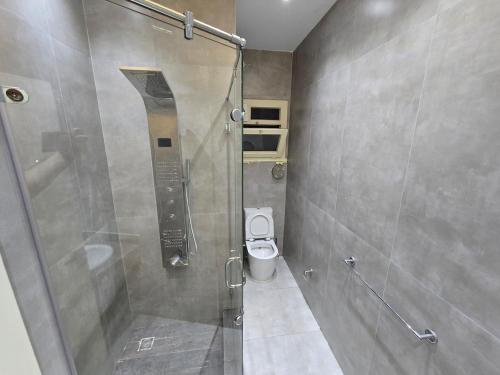 a bathroom with a shower and a toilet at Sea Apartment -Families Only in Alexandria