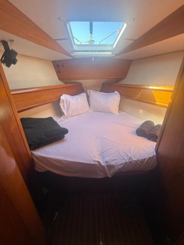 a small bed in the middle of a boat at Hope Boat 42 Limanu in Limanu