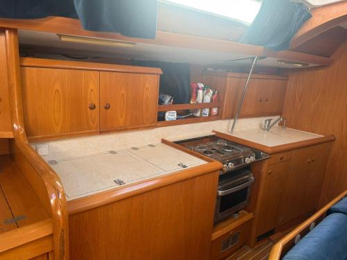 a small kitchen with a stove and a sink at Hope Boat 42 Limanu in Limanu
