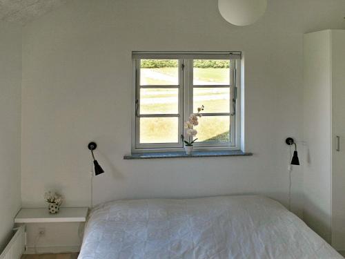 a bedroom with a bed and a window at 10 person holiday home in Nysted-By Traum in Nysted