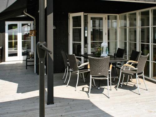 a patio with a table and chairs on a patio at 10 person holiday home in Nysted-By Traum in Nysted