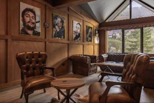 a living room with portraits on the walls at Grand Chamois Hotel & Spa in Mavrovo