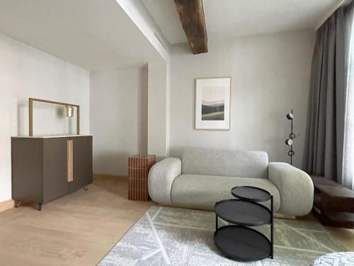 a living room with a couch and two chairs at Hotel Maison Maastricht Centrum - Handwritten Collection in Maastricht