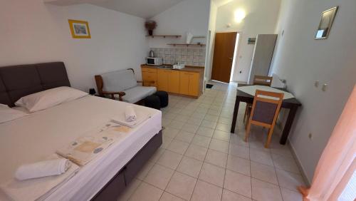a small room with a bed and a kitchen at Beachfront House Nella with full privacy in Jasenice