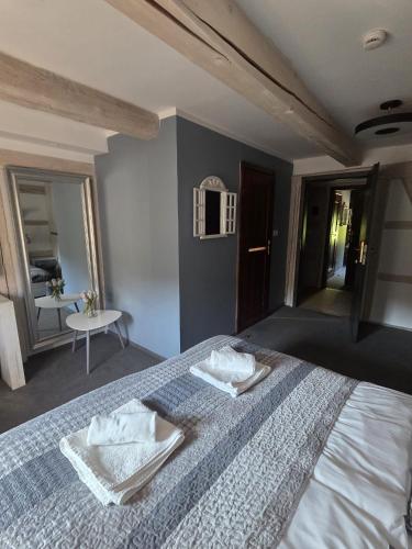 a bedroom with a bed with two towels on it at Nowa Prowansja 