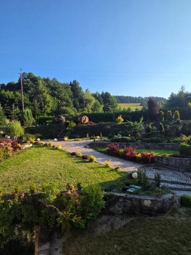 a garden with many flowers and a pathway at Nowa Prowansja 