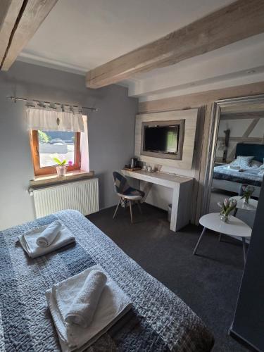a bedroom with two beds and a desk and a bed at Nowa Prowansja 