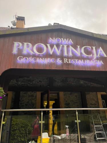 a building with a sign on the side of it at Nowa Prowansja 