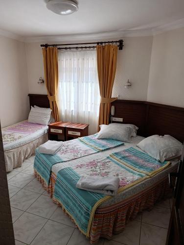 a bedroom with two beds and a window at uç su havuzlu termal in Kızılcahamam