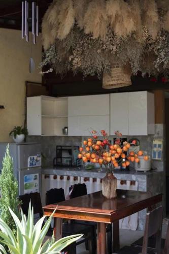 a kitchen with a table with a bunch of oranges on it at North House in Tây Ninh