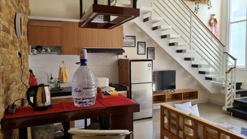 a bottle of water sitting on a table in a kitchen at Serene Villa in Batu with 3 Bedrooms and a Rooftop in Batu