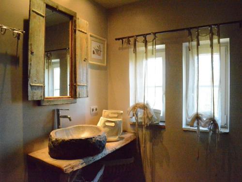 a bathroom with a sink and a mirror at Forest Cottage, Jehonville in Jehonville