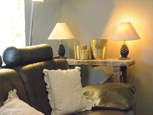 a living room with a couch and a table with lamps at Forest Cottage, Jehonville in Jehonville