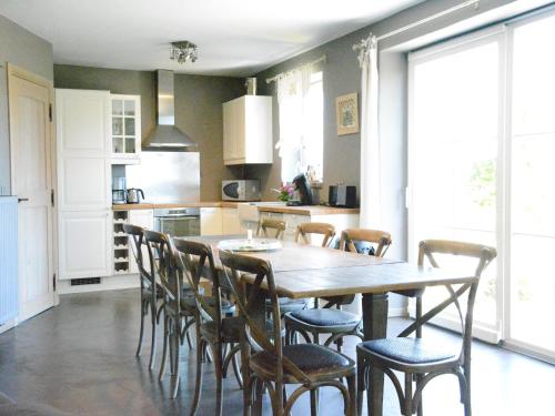 a kitchen with a wooden table and chairs at Forest Cottage, Jehonville in Jehonville