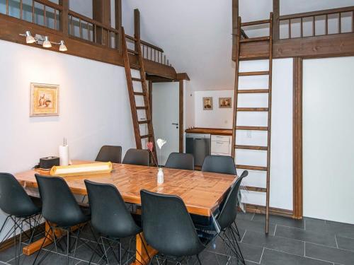 a room with a table and chairs and a loft bed at 5 star holiday home in Ansager in Ansager