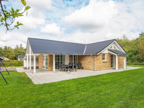 a brick house with a solar roof at 5 star holiday home in Ansager in Ansager