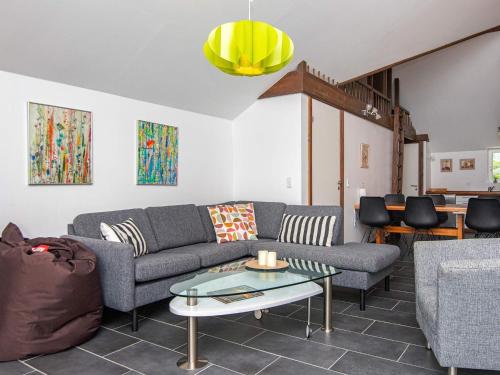 a living room with a couch and a table at 5 star holiday home in Ansager in Ansager
