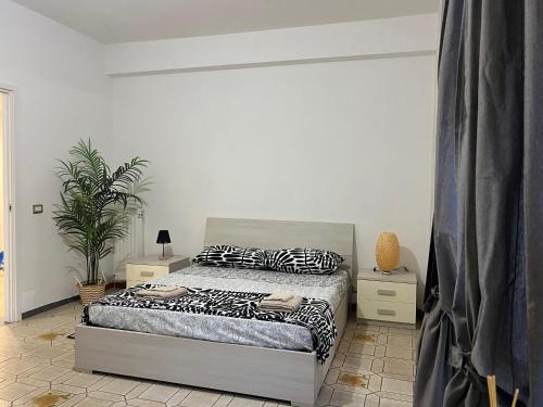 a bedroom with a bed and two night stands at Oleandri Concept Apartment in Rome