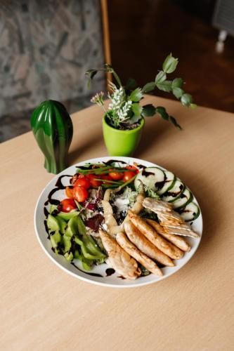 a plate of food with vegetables on a table at Pension Zschirnsteinbaude in Kleingießhübel