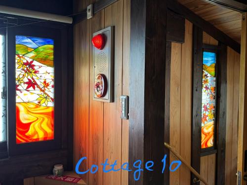 a door with three stained glass windows in a room at Tsuyukusa in Takayama
