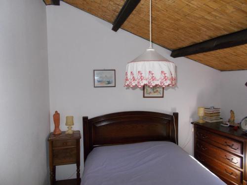 a bedroom with a bed and a pendant light at Le journal Blanc in Notre-Dame-de-Monts