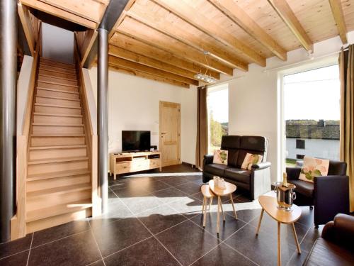 a living room with a staircase and a television at Cosy Holiday Home in Durbuy with Garden in Durbuy