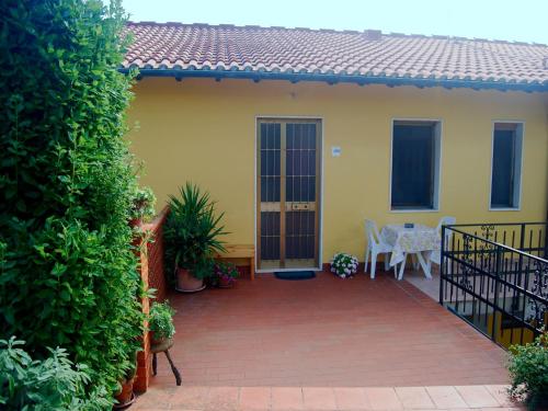 a patio of a house with a table and chairs at Sunlit home with pool in Fucecchio