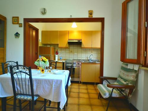 a kitchen with a table with a white table cloth at Sunlit home with pool in Fucecchio