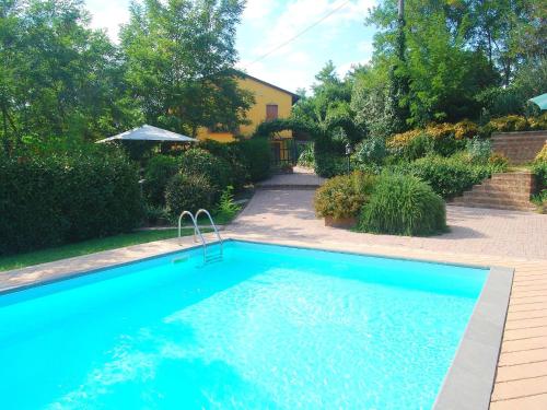 a large blue swimming pool in a yard at Sunlit home with pool in Fucecchio
