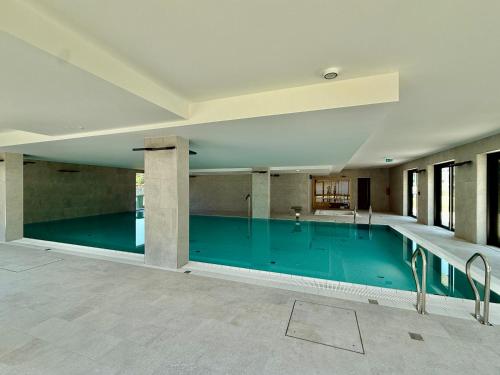 an empty swimming pool in a building at Rezydencja Niechorze MORSKIE WIDOKI 313 z Basenem i SPA - 5D Apartments in Niechorze