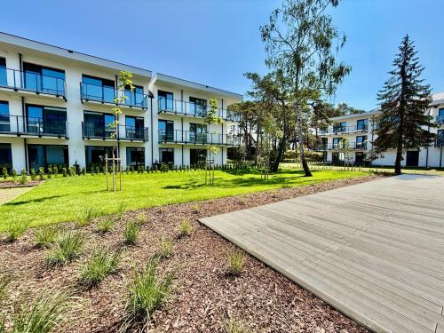 a boardwalk in front of a large building at Rezydencja Niechorze MORSKIE WIDOKI 313 z Basenem i SPA - 5D Apartments in Niechorze