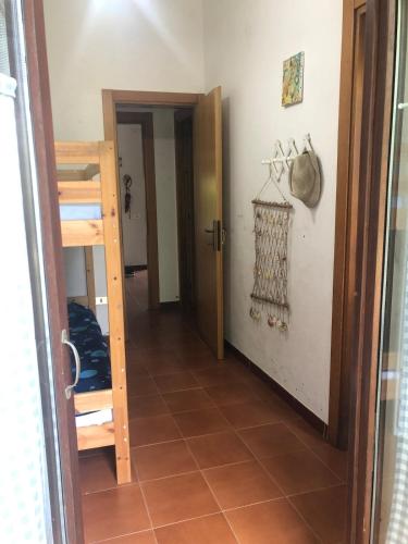 a hallway with a staircase and a room with a door at Villetta Simius Luxury in Simius