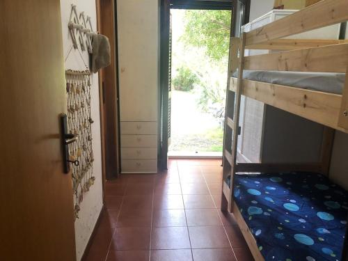 a hallway with two bunk beds in a room at Villetta Simius Luxury in Simius