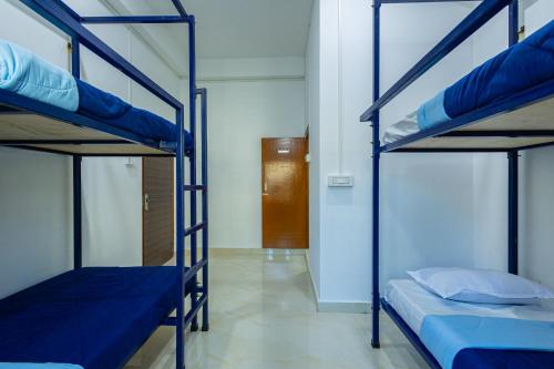 a room with two bunk beds and a hallway at Hostello Backpackers in Dibrugarh